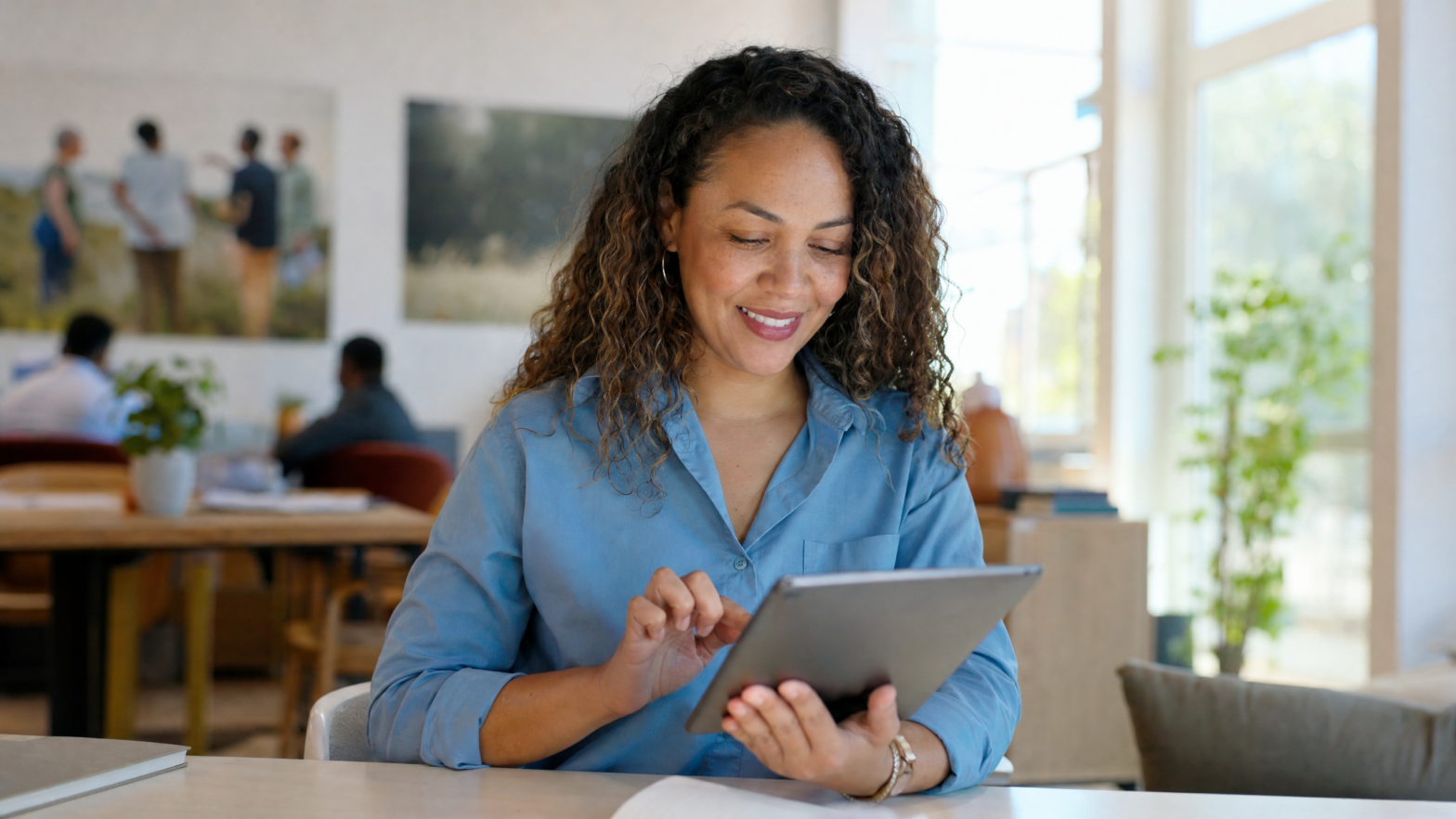 Nonprofit director reviewing digital fundraising results on a laptop with a warm smile