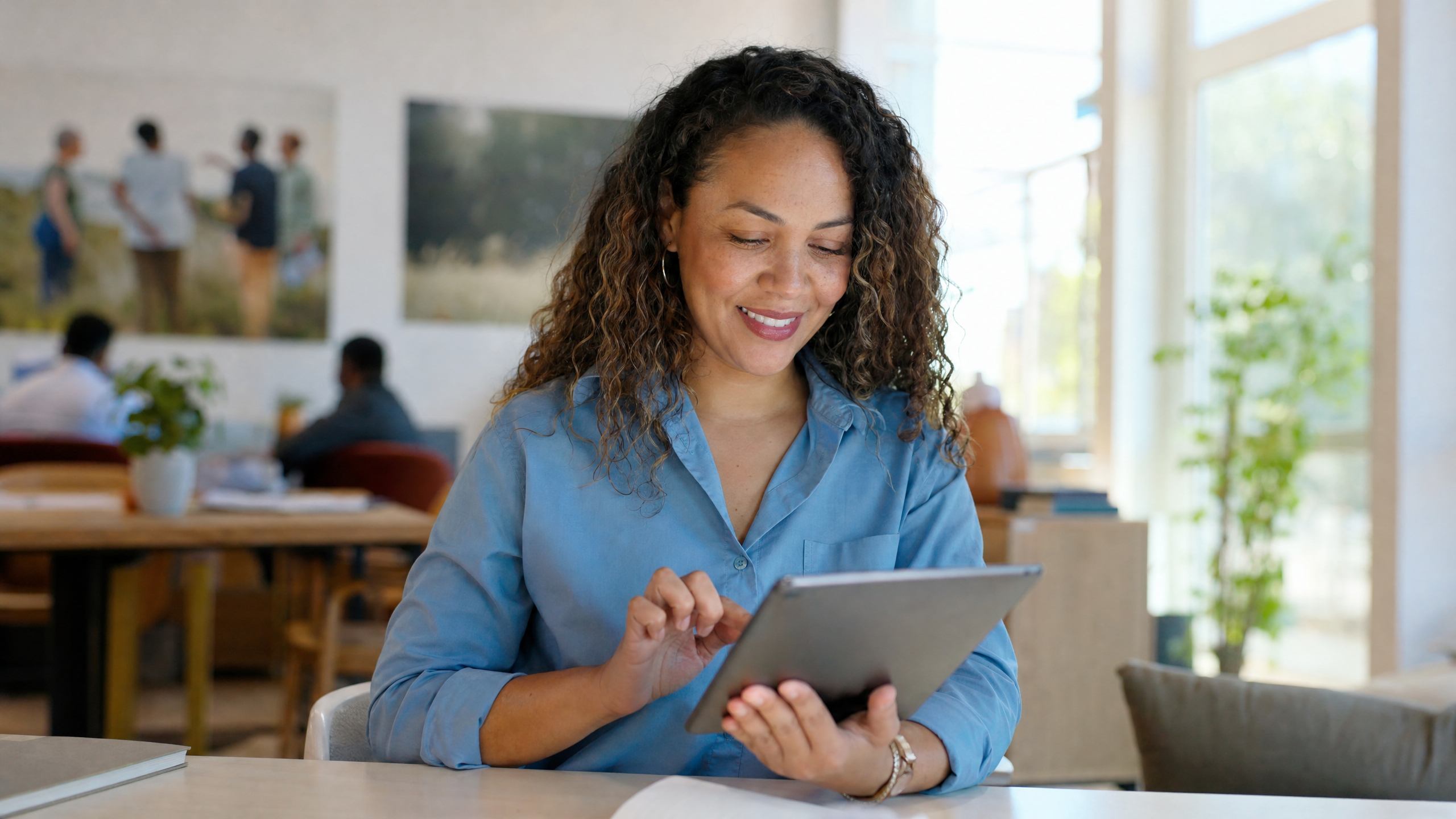 Nonprofit director reviewing digital fundraising results on a laptop with a warm smile